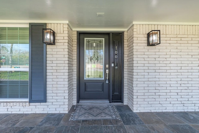 property entrance with brick siding