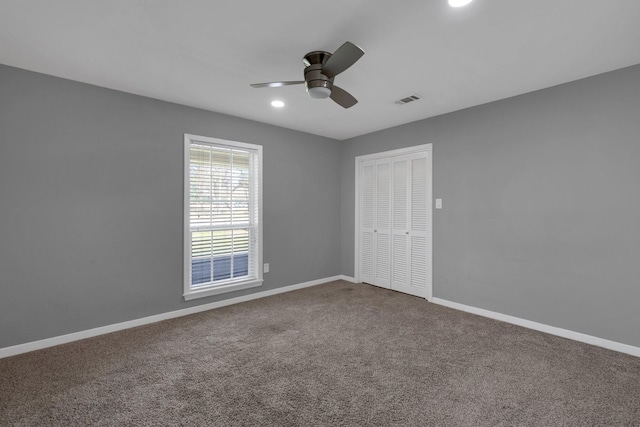 carpeted spare room featuring recessed lighting, visible vents, baseboards, and ceiling fan