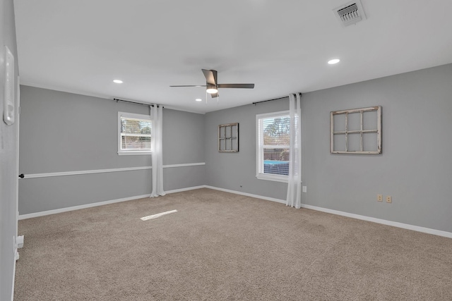 empty room with baseboards, visible vents, carpet floors, recessed lighting, and ceiling fan