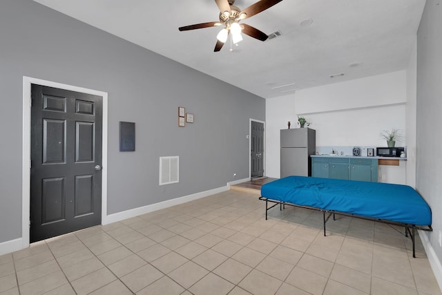 bedroom featuring visible vents, baseboards, and freestanding refrigerator