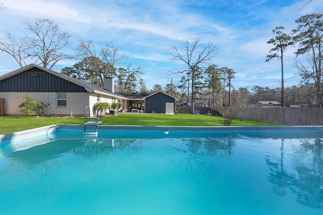 view of pool featuring a fenced in pool, a lawn, and fence