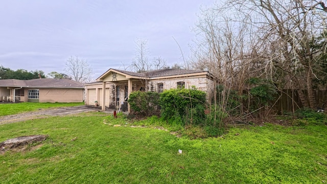 view of front of property with a front lawn, an attached garage, brick siding, and driveway