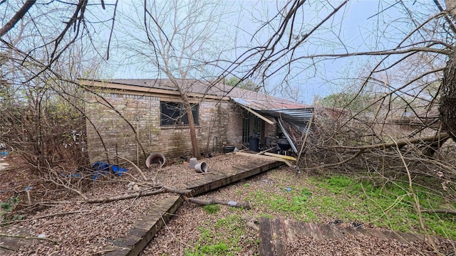 view of side of property with brick siding