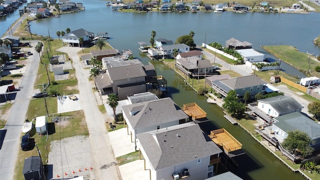 drone / aerial view with a residential view and a water view