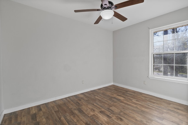 empty room featuring a ceiling fan, wood finished floors, and baseboards