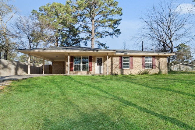 single story home with brick siding, a carport, a front lawn, and fence