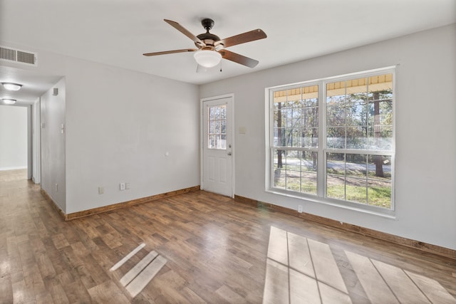 entrance foyer featuring visible vents, baseboards, wood finished floors, and a ceiling fan