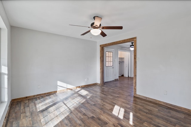 unfurnished room featuring ceiling fan, baseboards, and wood finished floors