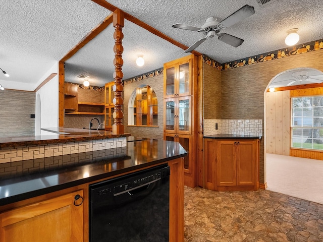 kitchen with tasteful backsplash, black dishwasher, dark countertops, and brown cabinetry