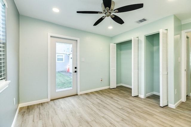 unfurnished bedroom with recessed lighting, wood finished floors, visible vents, and baseboards