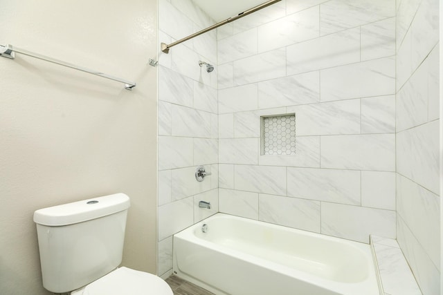 bathroom featuring toilet and bathtub / shower combination