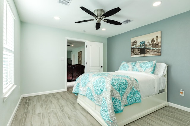 bedroom featuring wood finished floors, baseboards, and visible vents