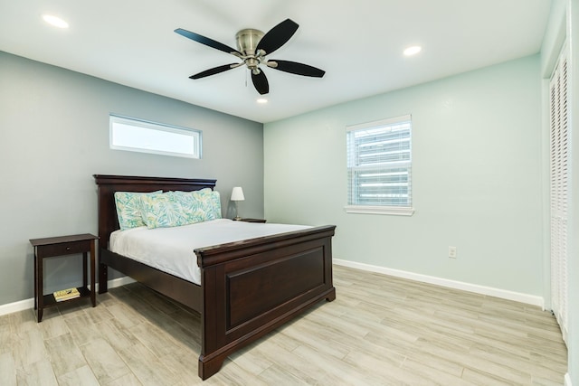 bedroom with recessed lighting, light wood-type flooring, and baseboards