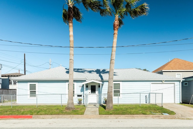 view of front of property featuring a gate, an attached garage, driveway, and a fenced front yard