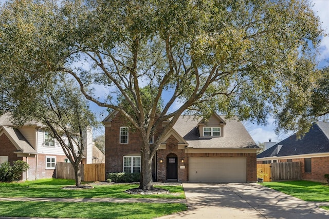 traditional home with brick siding, concrete driveway, and fence