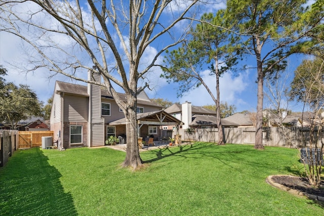 view of yard with a patio, cooling unit, and a fenced backyard