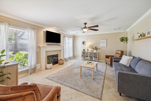 living room featuring visible vents, crown molding, a fireplace with flush hearth, light tile patterned flooring, and a ceiling fan