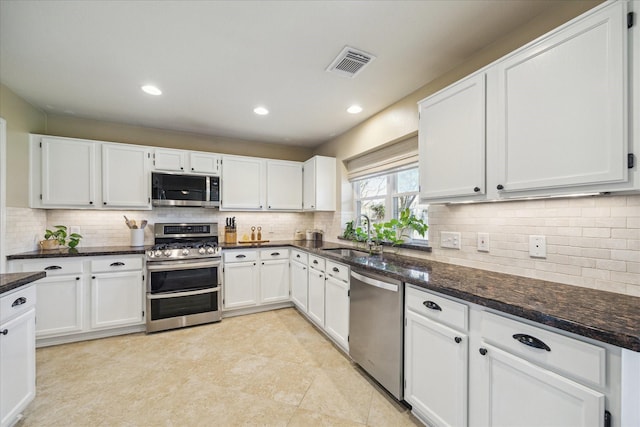 kitchen featuring a sink, visible vents, appliances with stainless steel finishes, and white cabinets