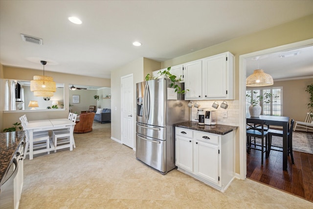 kitchen featuring tasteful backsplash, visible vents, pendant lighting, stainless steel appliances, and white cabinetry