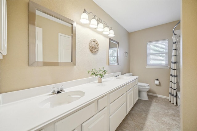 full bathroom featuring a sink, baseboards, toilet, and double vanity