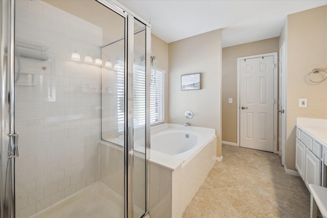 bathroom featuring vanity, a garden tub, baseboards, and a stall shower