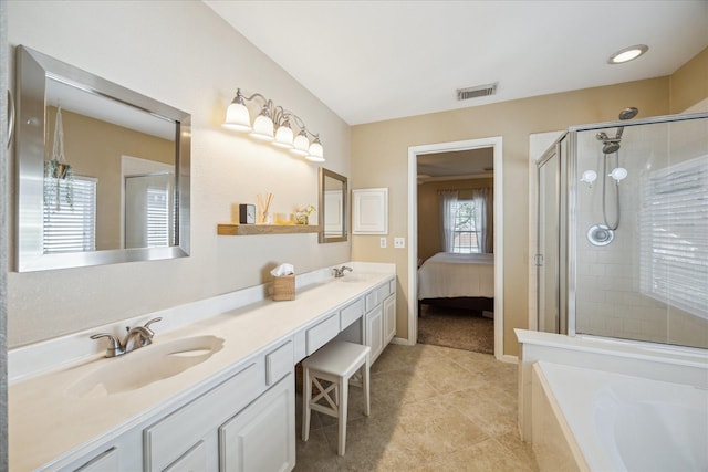 full bath featuring visible vents, double vanity, a sink, tile patterned flooring, and a shower stall