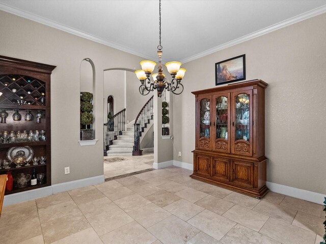 unfurnished dining area with arched walkways, baseboards, a chandelier, stairs, and ornamental molding