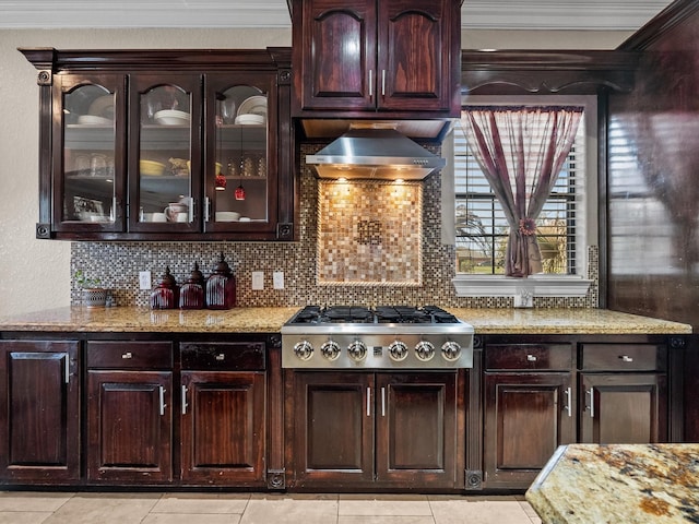 kitchen featuring wall chimney exhaust hood, stainless steel gas cooktop, backsplash, and light tile patterned floors