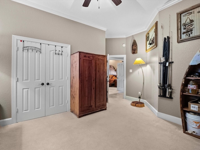 bedroom with light carpet, ornamental molding, a closet, baseboards, and ceiling fan