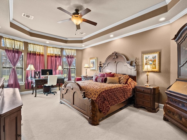 bedroom featuring a tray ceiling, visible vents, carpet floors, crown molding, and baseboards