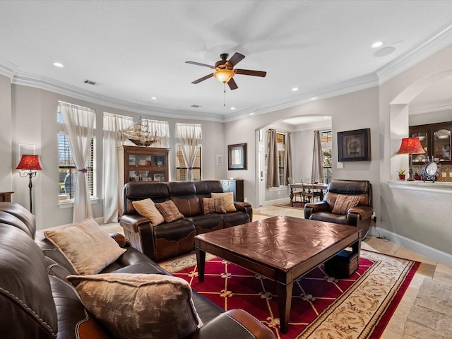 living room with baseboards, visible vents, recessed lighting, arched walkways, and ornamental molding