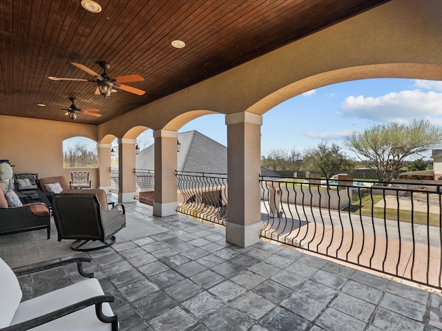 view of patio / terrace with outdoor lounge area, a ceiling fan, and fence