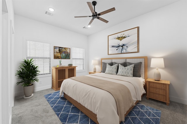 carpeted bedroom featuring visible vents, ceiling fan, and baseboards