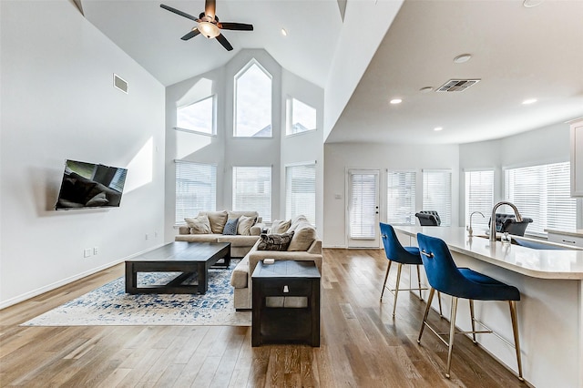 30715 Parkside Passage Dr, Fulshear, TX 77441 - living room with a ceiling fan, wood finished floors, baseboards, recessed lighting, and high vaulted ceiling
