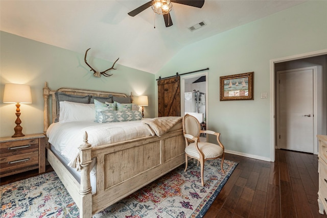 bedroom featuring visible vents, ceiling fan, a barn door, vaulted ceiling, and dark wood-style flooring