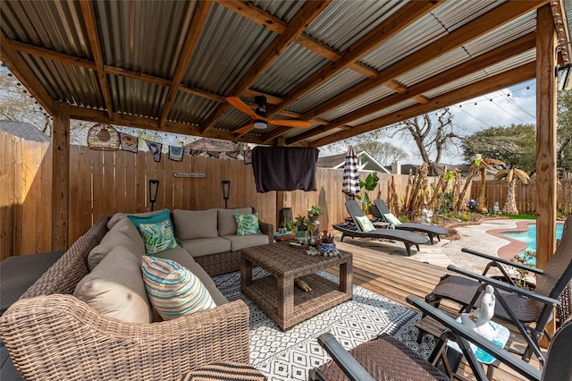 view of patio featuring a fenced backyard, a wooden deck, outdoor lounge area, a fenced in pool, and ceiling fan