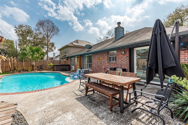 view of swimming pool featuring outdoor dining space, a patio, a fenced backyard, a fenced in pool, and a hot tub