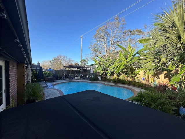 view of swimming pool with a gazebo, a fenced backyard, a fenced in pool, and a patio