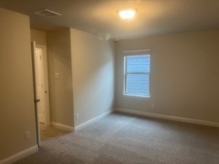 unfurnished room featuring visible vents, baseboards, and carpet floors