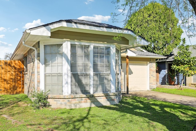 view of property exterior featuring concrete driveway, an attached garage, brick siding, and a yard