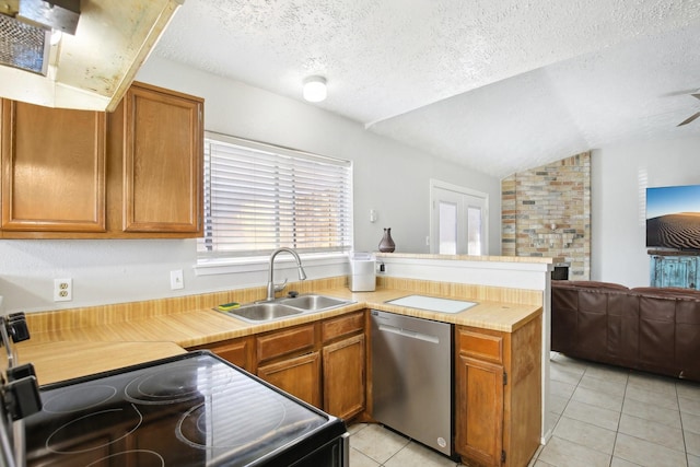 kitchen featuring a peninsula, a sink, black electric range, stainless steel dishwasher, and open floor plan