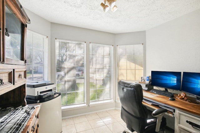 office area featuring light tile patterned floors, baseboards, and a textured ceiling