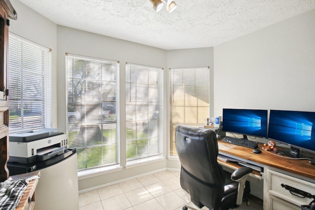 office with light tile patterned floors, baseboards, and a textured ceiling