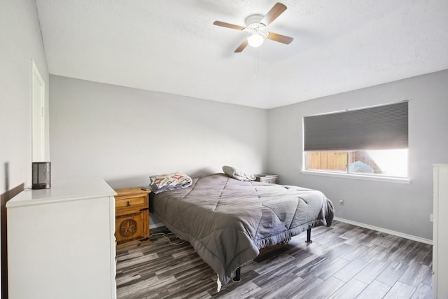 bedroom with baseboards, wood finished floors, and a ceiling fan