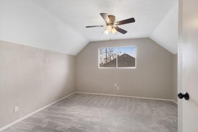 bonus room featuring carpet flooring, a textured ceiling, baseboards, and vaulted ceiling