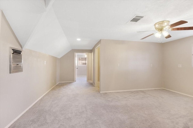 additional living space with visible vents, baseboards, vaulted ceiling, carpet floors, and a ceiling fan