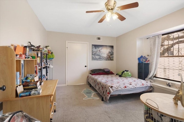 bedroom with visible vents, carpet floors, and a ceiling fan