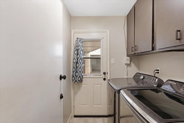 laundry area with cabinet space and independent washer and dryer