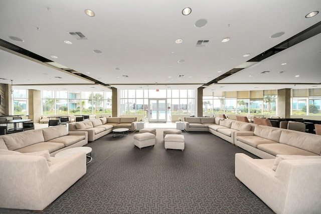 living area with a wall of windows, recessed lighting, and visible vents