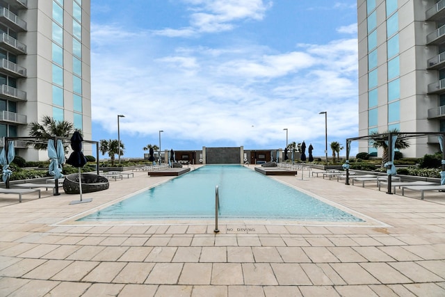 view of swimming pool featuring a patio area